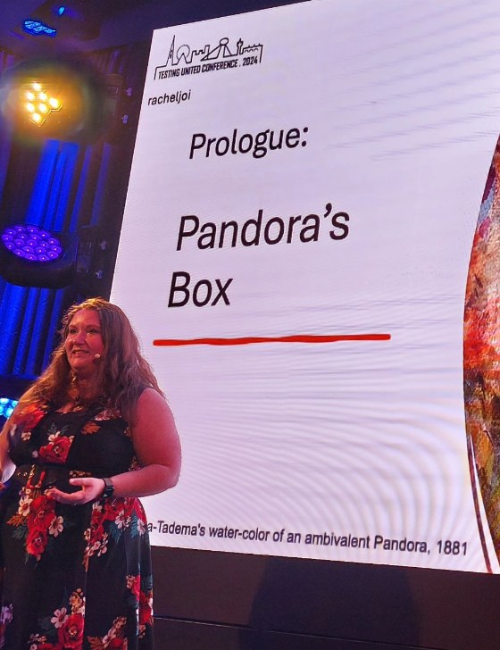 Rachel presenting beside a screen titled “Prologue: Pandora’s Box” at Testing United 2024